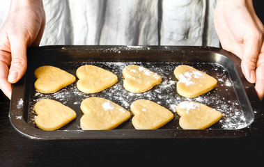 cooking homemade cookies with hands on dark background