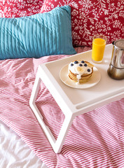 concept of breakfast in bed on tray with juice