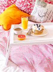 concept of breakfast in bed on tray with juice