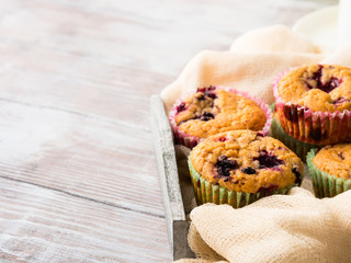Berry muffins in wooden tray napkin textile. Spring summer holiday breakfast set with tea
