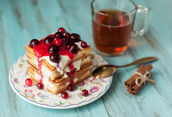 tea and dessert, Viennese waffles for breakfast. On wood, turquoise background
