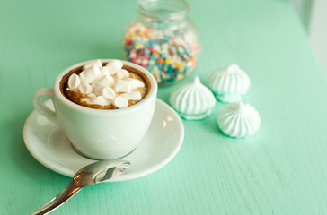 Morning cappuccino coffee with dessert at the cafe. On wood, turquoise background