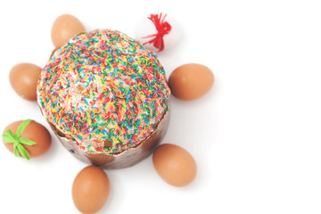 Easter eggs lie around cake on white background
