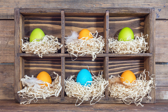 Easter colorful eggs in the nests in cell boxes
