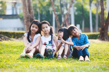 Fototapeta premium Four happy smiling child playing in park