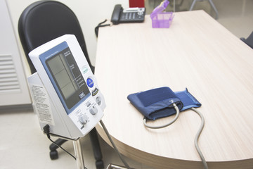 digital blood pressure monitor cuft on the desk in hospital