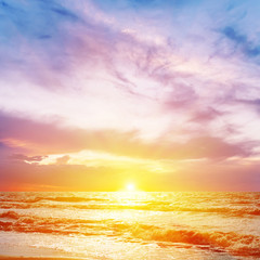 Fototapeta na wymiar light purple sunset over orange color sea