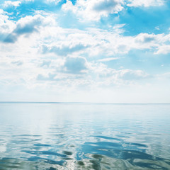 Fototapeta na wymiar water closeup with waves and dark clouds in blue sky