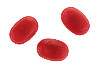 Top view of three menthol cherry flavored cough drops isolated on a white background.