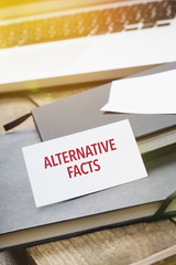 Card saying Alternative Facts on note pad