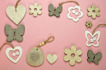 pink wooden empty copy space background with spring butterfly, flower and heart shape decoration made of wood