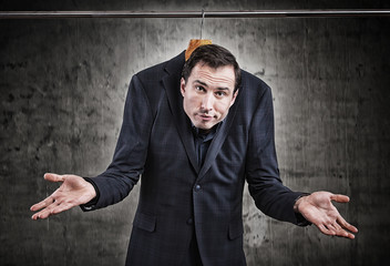 Man in suit hanging in the wardrobe. Embarrassing situation concept

