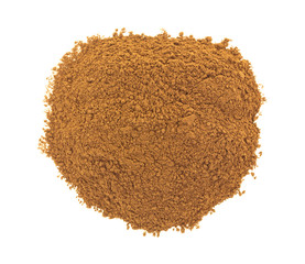 Top view of a pile of carob powder isolated on a white background.