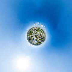 Aerial city view with crossroads and roads, houses, buildings, parks and parking lots, bridges. Urban landscape. Copter shot. Panoramic image.