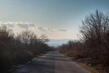 Beautiful landscape of country side road with trees in winter time at sunset. Azerbaijan, Caucasus, Sheki, Gakh, Zagatala