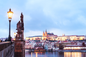 Scenic view to Lesser Town (Mala Strana), Prague Castle and Charles Bridge from the other side Vltava river, illuminated by the city lights. 