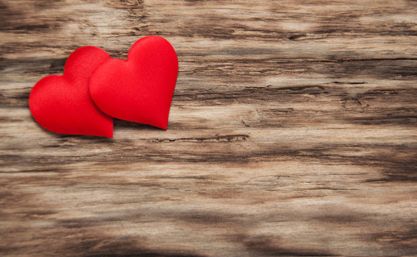 Red hearts on a wooden background
