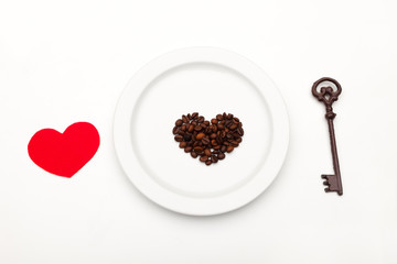 The key to heart on white. Heart on a plate. Coffee heart. Sweet heart. Valentine's Day. red heart on a plate. love card.