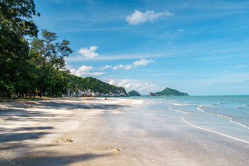 Outdoor landscape of beautiful secret tropical sea beach with gorgeous water in Khao Sam Roi Yot National Park, Thailand. Perfect vacation in Southeast Asia at exotic white sand beach and palm trees.