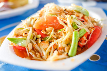 Som Tum Thai or Green Papaya Salad serve on styrofoam plate at Pattaya Thailand.