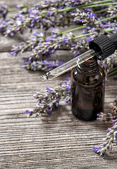 Obraz na płótnie Canvas Lavender oil essence dreied flowers wooden background