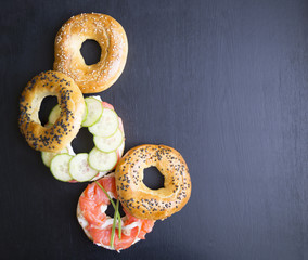 bagels with sesame seeds on a black background