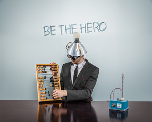 Be the hero text on blackboard with businessman