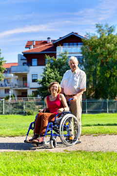 woman on wheelchair and older man