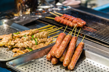 Hot dogs and kebabs on grill