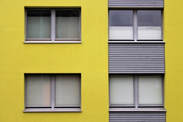 An Image of a house with yellow facade