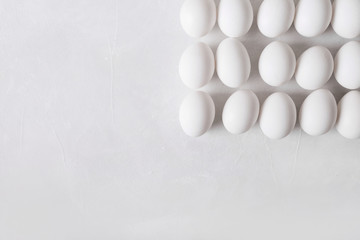White eggs in the form of a square on a white background. Easter Concept Photo