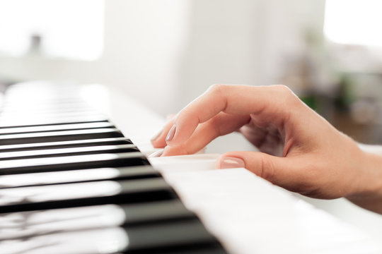 Closeup of hands playing piano. Music and hobby concept