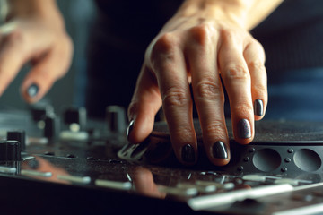 DJ playing music at mixer closeup