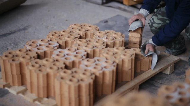 Work on the factory floor packs products. factory workers adds refractory bricks for further packaging.