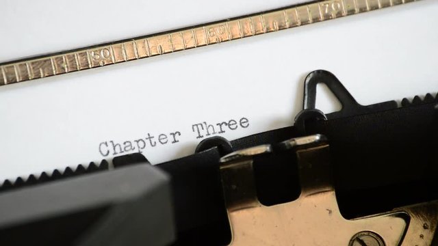 Typing the expression Chapter Three with an old manual typewriter