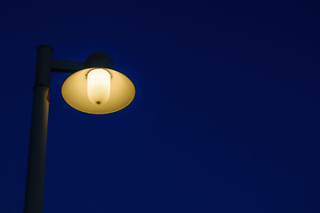 Edison lamp on wayside in countryside at night