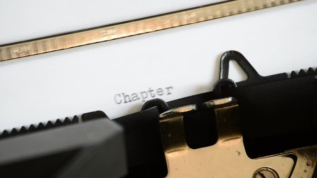 Typing the expression Chapter Four with an old manual typewriter