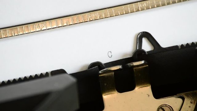 Typing the expression Chapter Five with an old manual typewriter