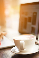 working and coffee cup on the wood table with sun rise