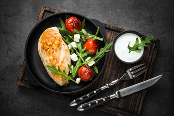 Grilled chiken fillet and fresh vegetables salad.