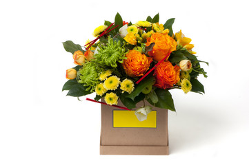 orange roses and an assortment of colors in cardboard box. Valentine's Day