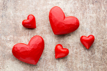 Red hearts on the wooden background.