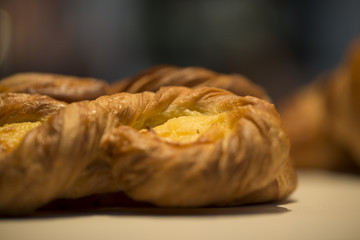 Closeup of croissant with cream in a showcase 