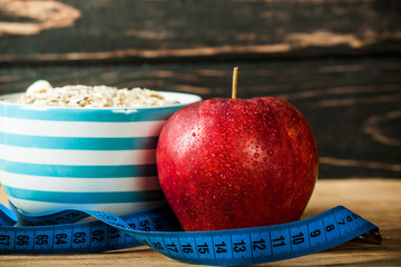 Fresh apple with measuring tape