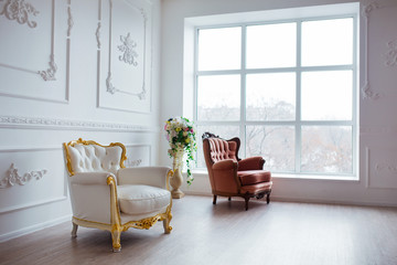 Vintage style chair in classical interior room with big window and flowers
