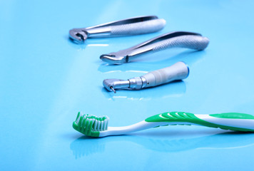 dental care toothbrush with dentist tools on mirror background.