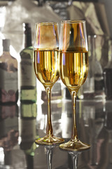 Celebration composition with two glasses white and red wine grapes on mirror table.