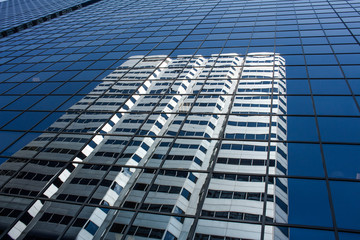 Abstract fragment of modern architecture, walls made of glass and concrete. Blue tonal filter photo...