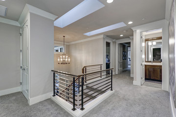 Second floor landing features skylight over the staircase
