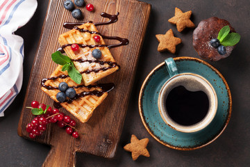 Coffee, sweets and waffles with berries